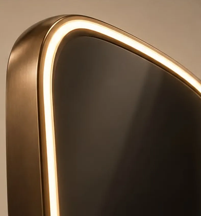 Close-up of the line of warm light between the bronze frame and the glass